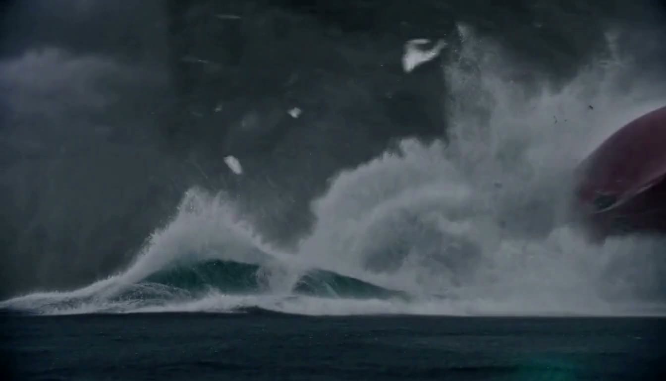A towering wave breaks as the storm hits